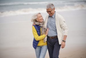 A couple walking on the beach together. 