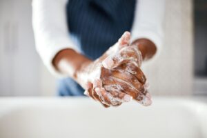 Soapy hands being washed properly using the right technique. 